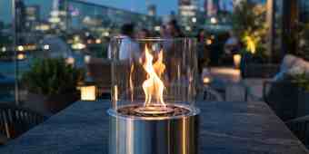 Tabletop fire pit with a spark screen on a covered balcony
