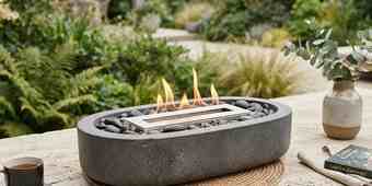 Fire pit with a protective spark screen in place